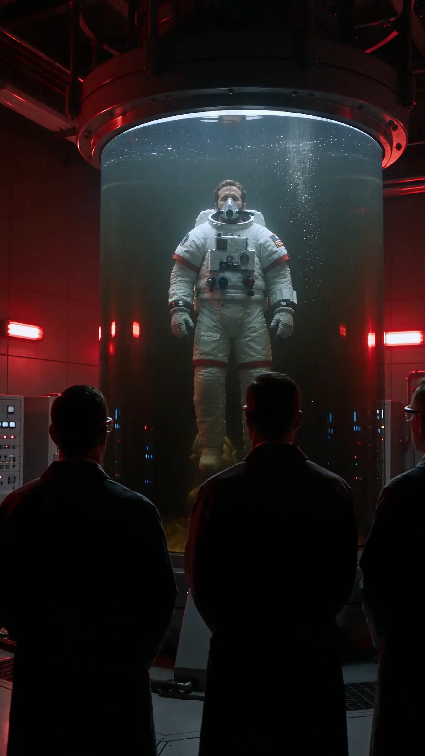 Astronaut suspended inside a red-lit laboratory chamber